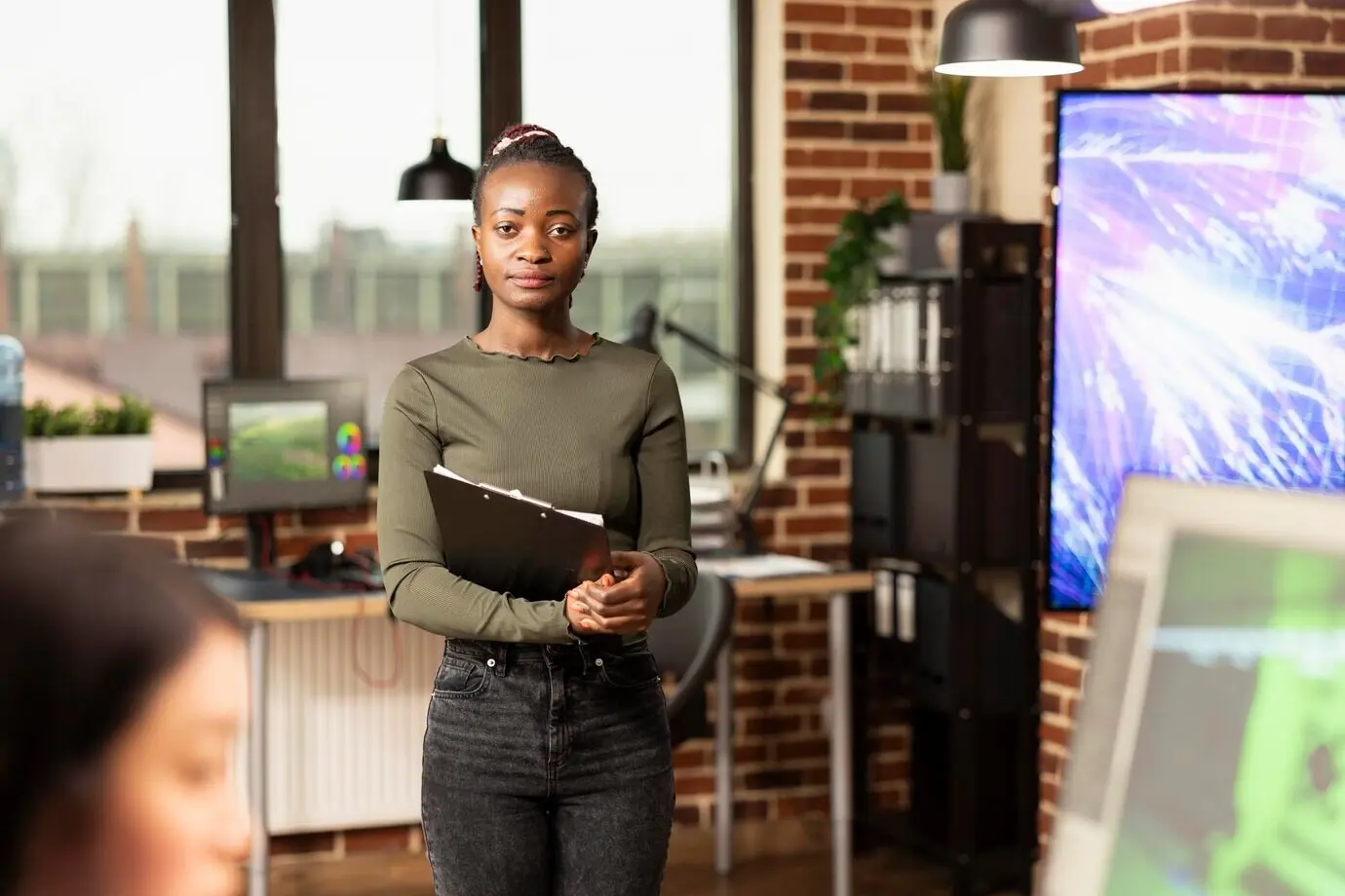Femme noire confiante dans un bureau moderne.